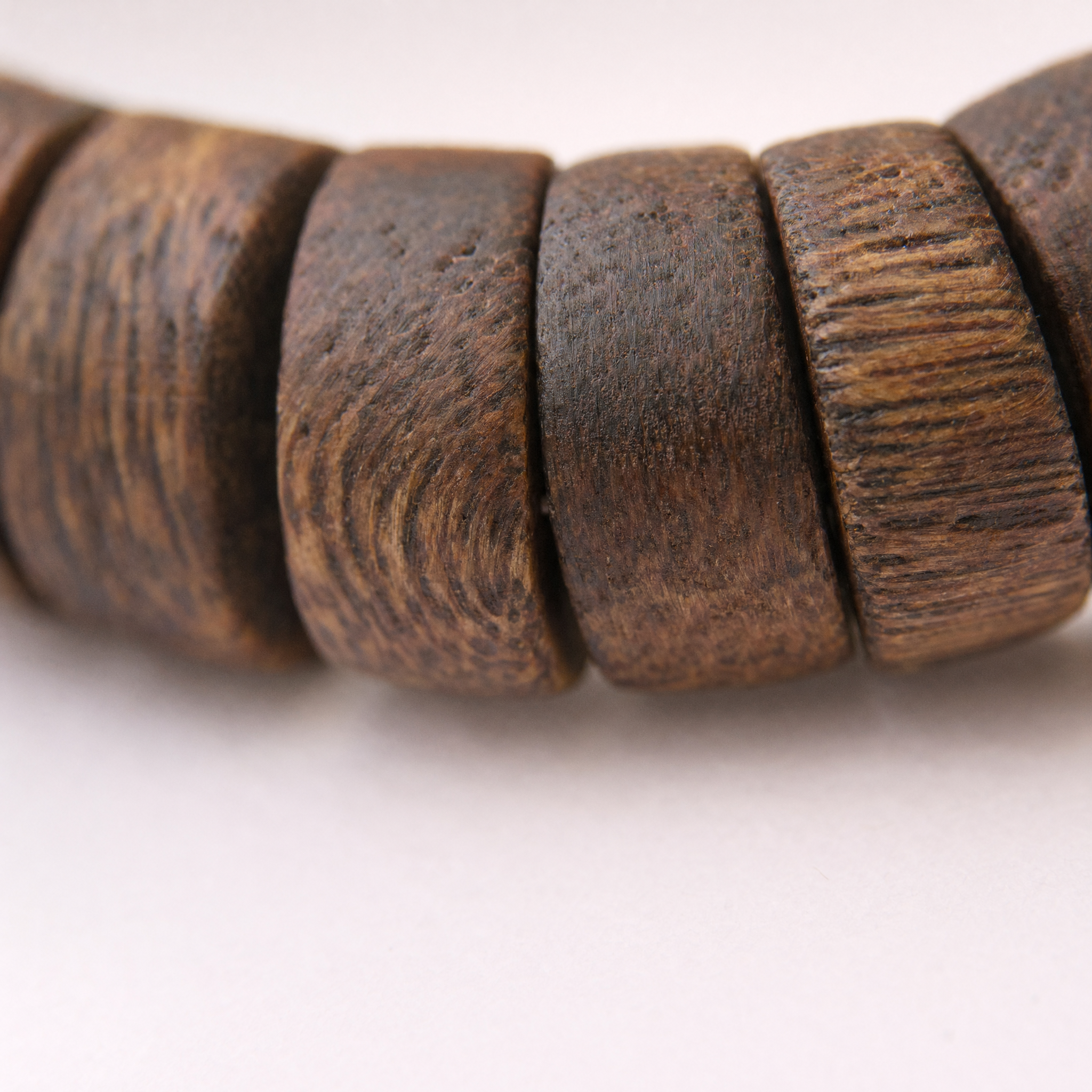 Close-up of slim agarwood barrel beads
