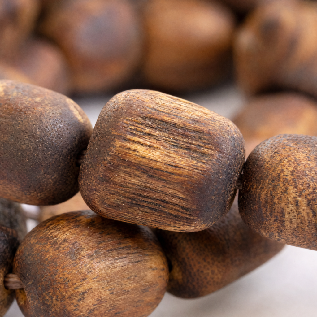 Close-up of rustic oval agarwood beads