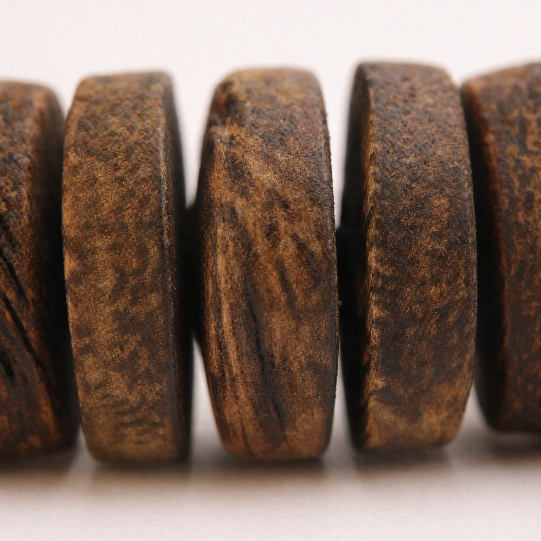 Close-up of stacked agarwood disc beads
