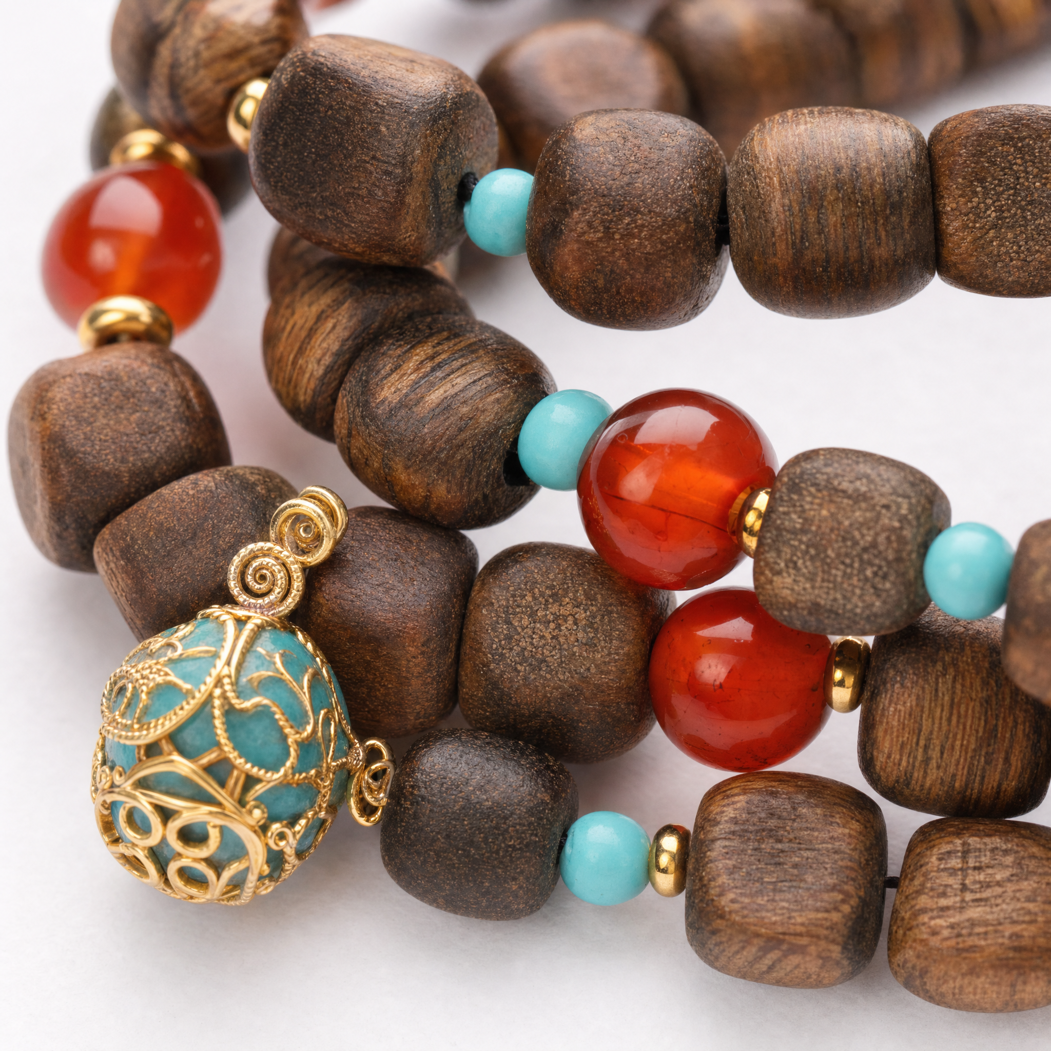Close-up of double wrap agarwood bracelet with turquoise and red beads