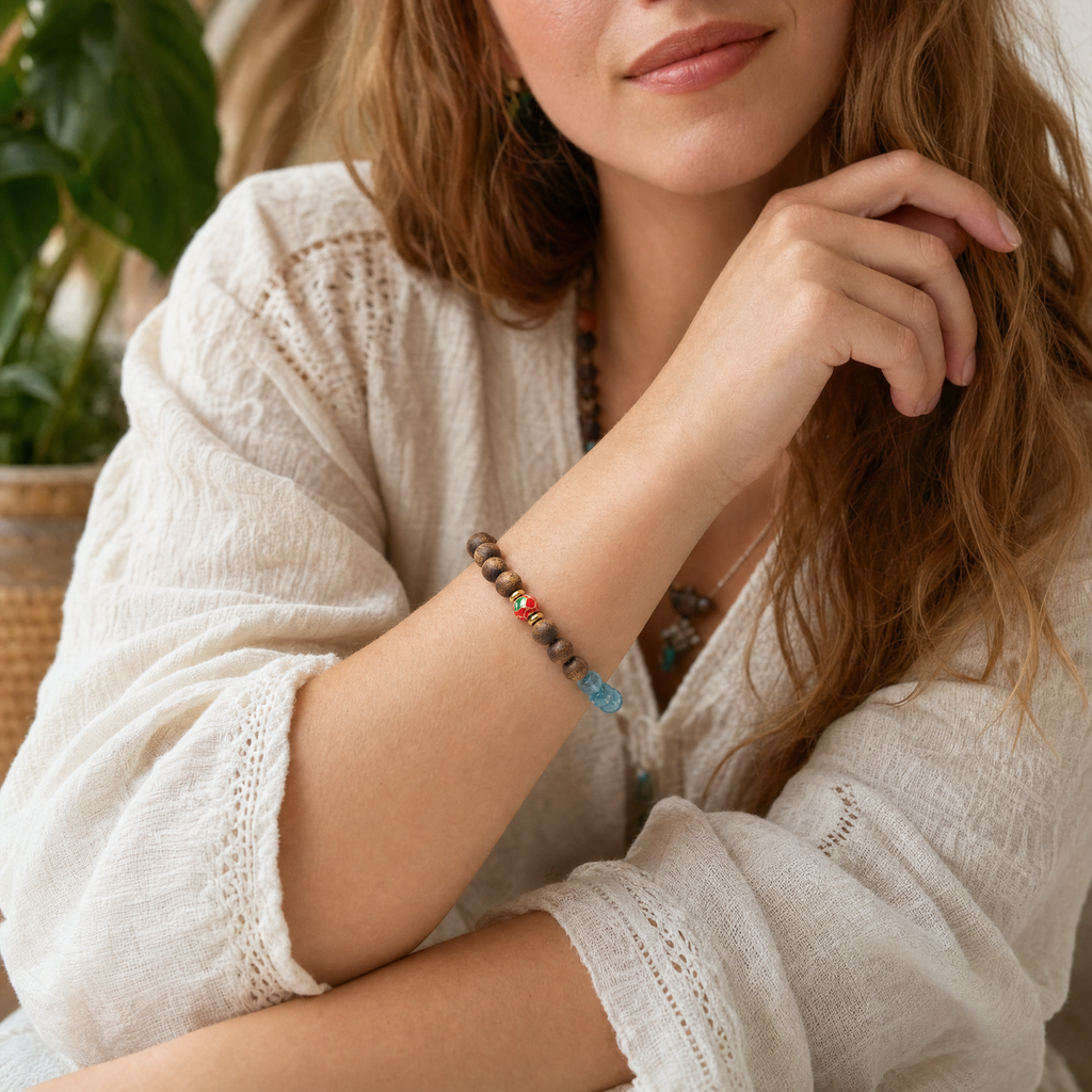 Woman wearing agarwood bracelet with blue crystal accent beads