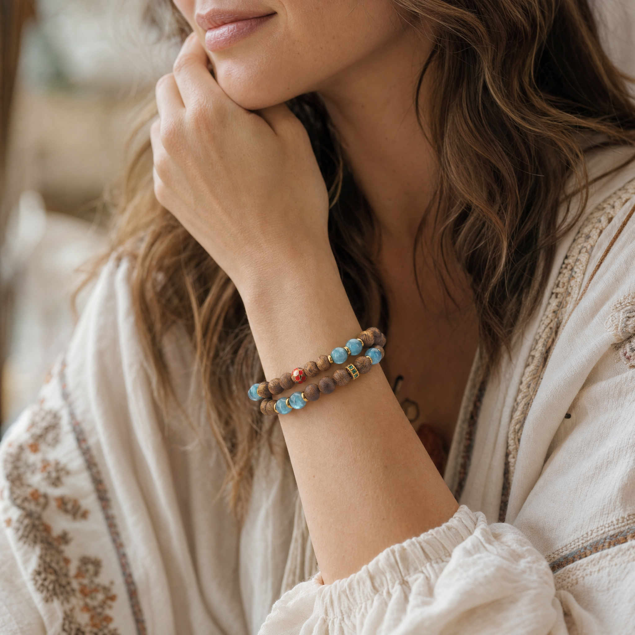 Woman wearing double wrap agarwood bracelet with blue accent beads