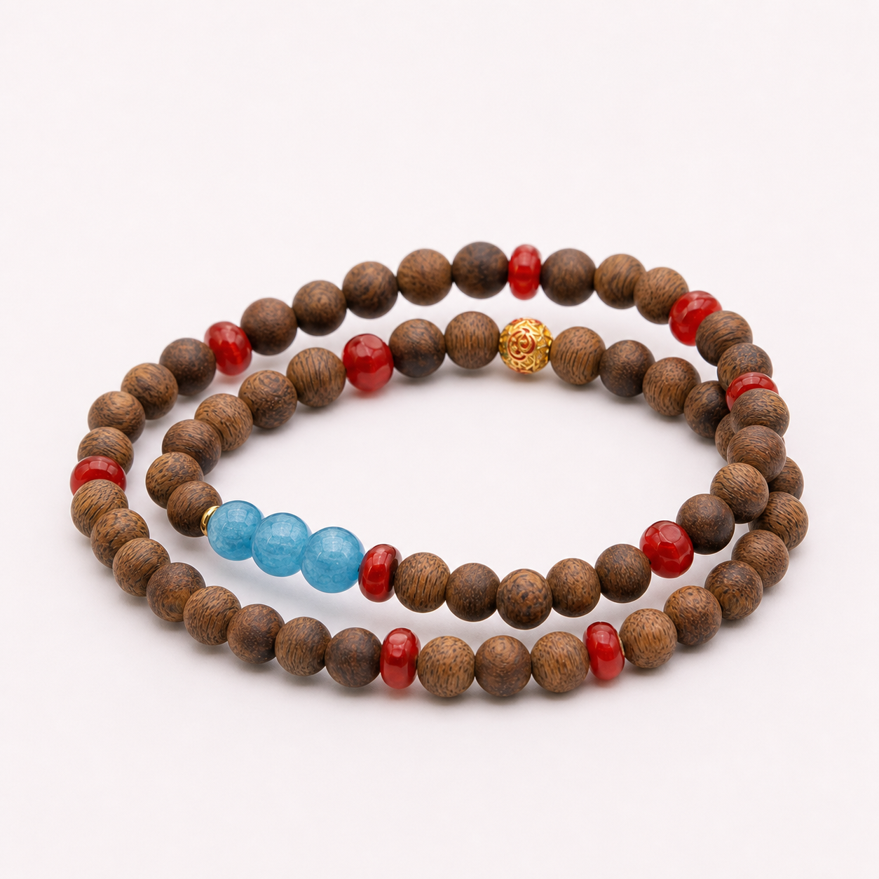 Single continuous double-wrap agarwood bracelet with blue and red accent beads on white background